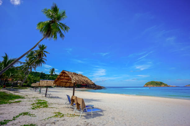 istock Beach chair with umbrella with blue sky on tropical beach 1327339398