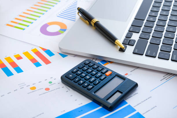 istock Laptop and pen with business charts, graphs, statistic and documents background for business and finance concepts 1327339442