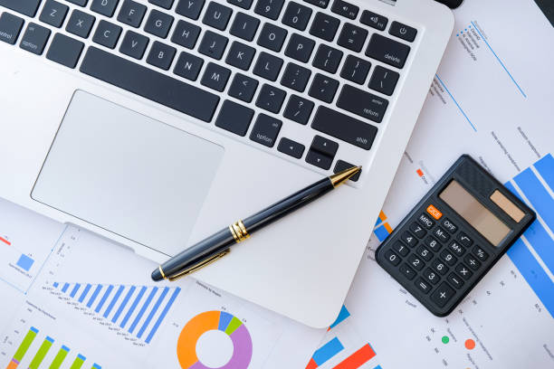 istock Laptop and pen with business charts, graphs, statistic and documents background for business and finance concepts 1327339445
