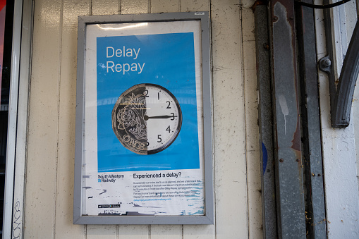 London, UK - July 6 2021: Worn South Western Railway delay repay sinage at Mortlake Station