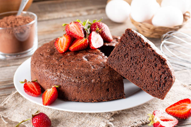 Homemade round chocolate sponge cake or chiffon cake with strawberry. Homemade bakery concept for background and wallpaper Homemade round chocolate sponge cake or chiffon cake so soft and delicious with strawberry. Homemade bakery concept for background and wallpaper chiffon stock pictures, royalty-free photos & images