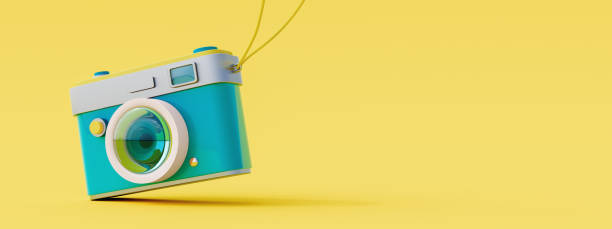 Blue retro camera on yellow background. Summer travel concept