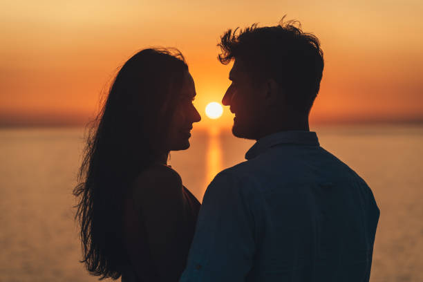 istock The two happy people standing on the beautiful sunset background 1327344070