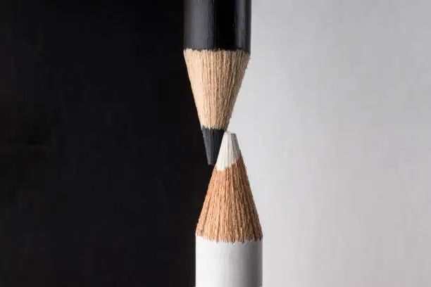 Photo of White and black pencils. Contrast and opposite concept