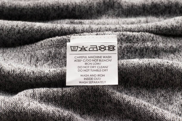istock Label on clothes. Delicate care. Gray fabric clothes 1327344855