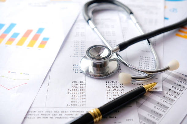 stethoscope with pen, charts and graphs, finance, account, statistics, investment, analytic research data economy spreadsheet and business company concept - rekening stockfoto's en -beelden