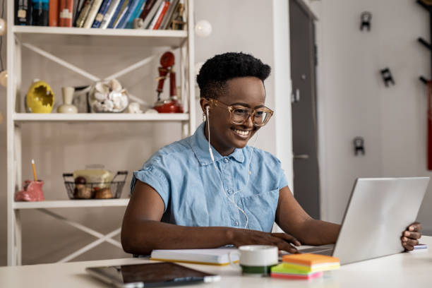 istock Cute young woman working on the laptop 1327345463