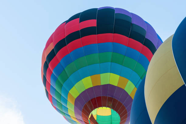 istock Multicolored hot air balloon on blue cloudy sky background 1327348799