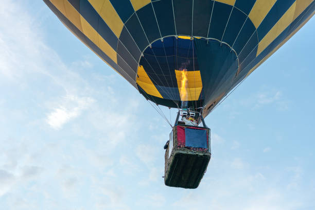 istock Multicolored hot air balloon on blue cloudy sky background 1327348806