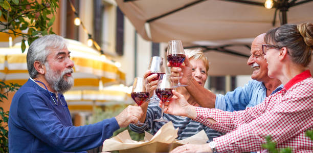 group of old people eating and drinking outdoor - senior couples having fun together - dining senior adult friendship mature adult imagens e fotografias de stock