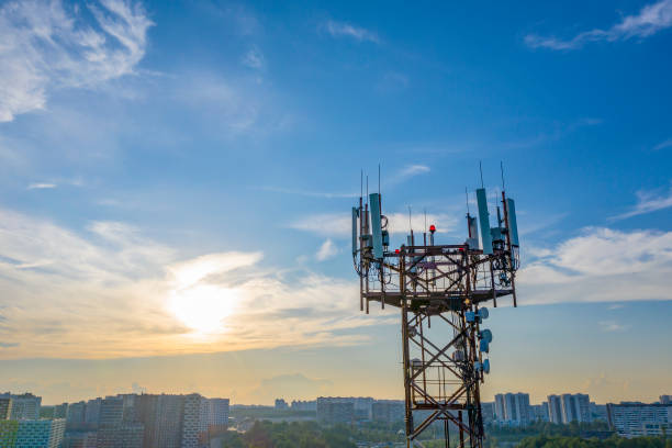 istock Silhouette communication tower mobile operator's antenna against the background city blocks and the evening blue sky. 1327351944