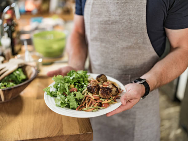 istock Young man cooking Italian meal in home kitchen 1327356157