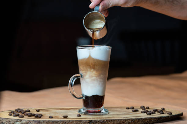 Latte macchiato with whipped cream and caramel sauce in tall Latte macchiato with whipped cream and caramel sauce in tall cafe macchiato stock pictures, royalty-free photos & images