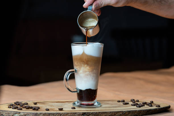 latte macchiato with whipped cream and caramel sauce in tall - caramel latté coffee cafe macchiato imagens e fotografias de stock