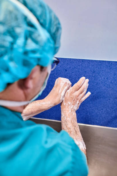 istock unrecognizable surgeon man washing his hands with soap before an operation in a hospital 1327356191