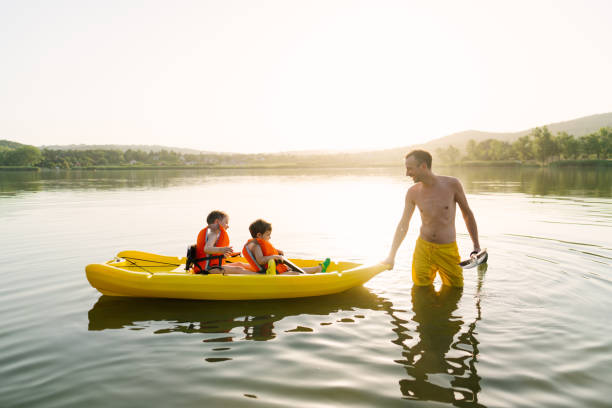 istock Father and sons kayaking on the lake 1327358730