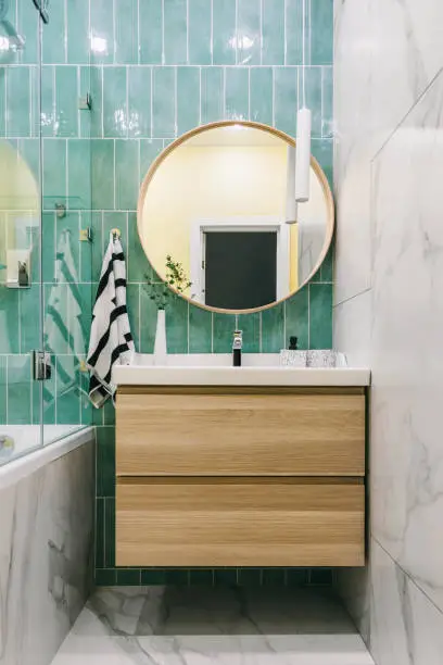 Stylish modern luxurious marble and green tiles bathroom with washbasin