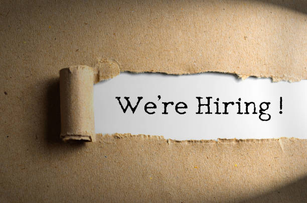 istock Torn paper with word We're Hiring 1327364074