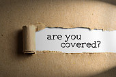 istock Torn paper with word are you covered 1327364098