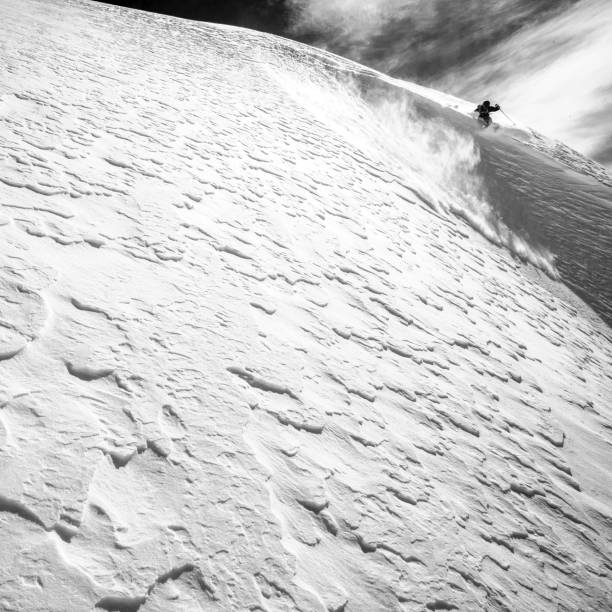 istock Backcountry skier descends snowy mountain ridge 1327364954