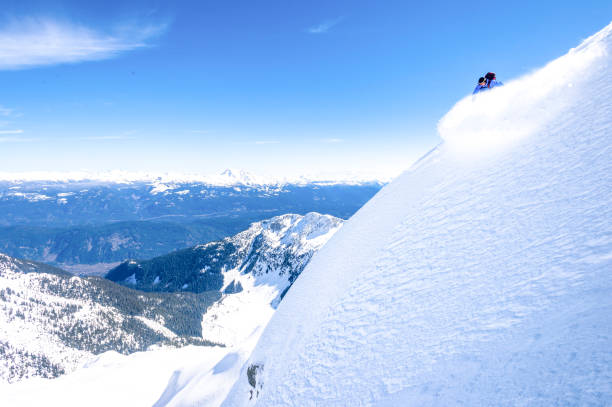istock Backcountry skier descends snowy mountain ridge 1327364978