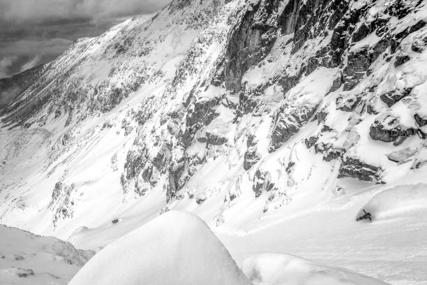 istock Backcountry skier descends snowy mountain ridge 1327365004
