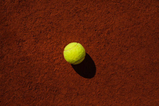 Tennis ball on the dirty ground after playing at the court for exercise or for fun.