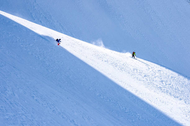 esquiador sertanejo e snowboarder descem montanha snowy ridge - telemark skiing skiing ski moving down - fotografias e filmes do acervo