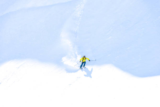 istock Backcountry skier descends snowy mountain ridge 1327366031