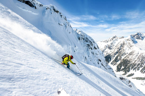 бэккантри лыжник спускается со снежного горного хребта - ski skiing telemark skiing winter sport стоковые фото и изображения