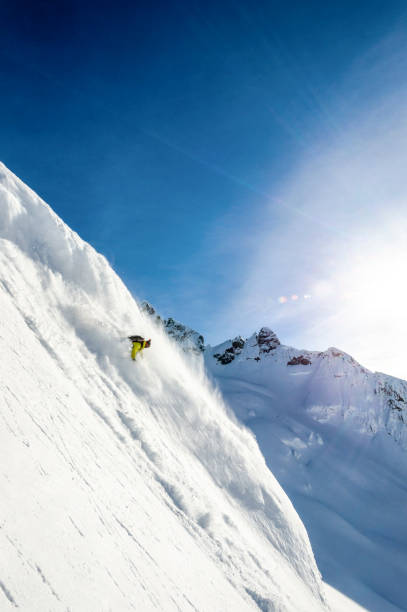 istock Backcountry skier descends snowy mountain ridge 1327366193