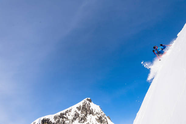 istock Backcountry skier descends snowy mountain ridge 1327366210