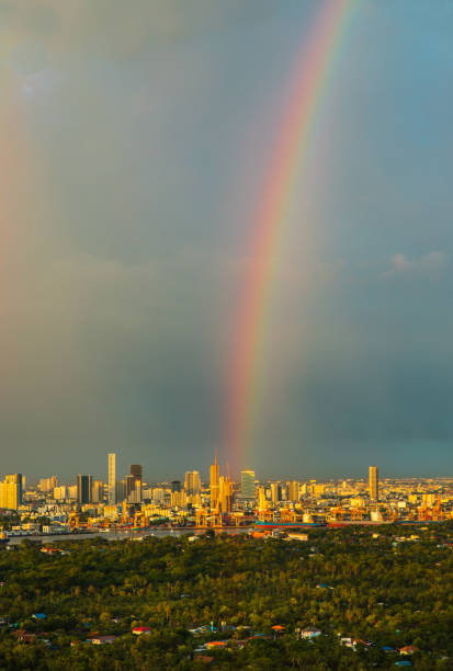 A colorful rainbow in the sky above skyscraper at bangkok. Creates relaxing feeling for the rest of the day, Copy space, Selective focus.