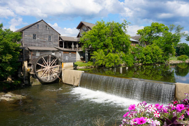 The Old Mill along the Little Pigeon River in Tennessee The Old Mill is an old gristmill in Pigeon Forge, Tennessee has been in operation since 1830. A popular tourist spot and restaurant. watermill stock pictures, royalty-free photos & images