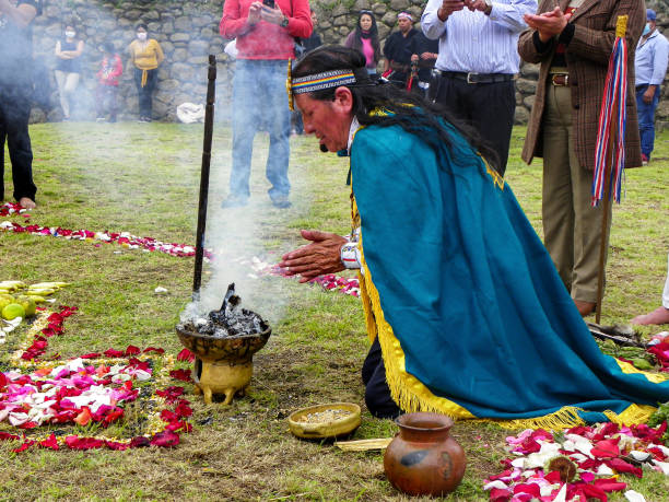 Shaman conducts spiritual ceremony Chacana Chobshi, Azuay province, Ecuador - June 21, 2021: Celebration Inti Raymi at Chobshi archeological site of ancient ruins of Cacique Duma Сastle. Shaman conducts spiritual indigenous ceremony Chacana inti raymi stock pictures, royalty-free photos & images