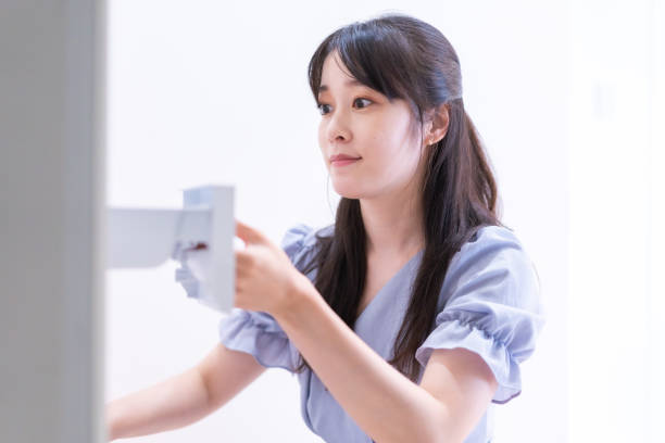 istock Young woman doing laundry at home 1327376860