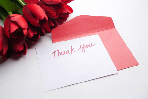 istock thank you message, envelope and red tulip flower on white background 1327383921