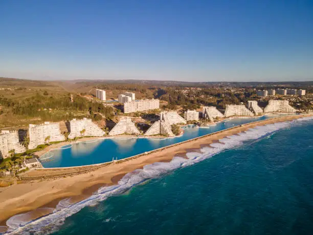 Aerial view of a huge swimming pool with modern buildings next to the beach at San Alfonso del Mar, Algarrobo, Chile