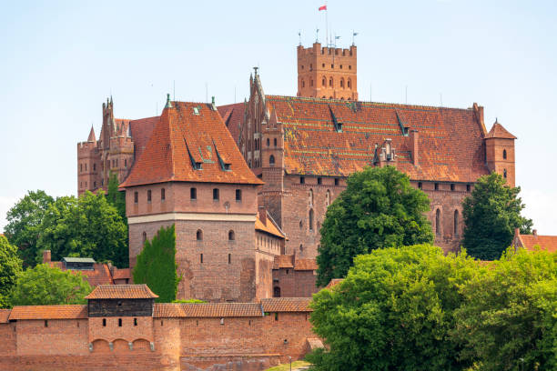 13th century Malbork Castle, medieval Teutonic fortress on the Nogat River, Malbork, Poland Malbork, Poland - June 25, 2020: 13th century Malbork Castle, medieval Teutonic fortress on the Nogat River.  It is the largest castle in the world, UNESCO World Heritage Site malbork photos stock pictures, royalty-free photos & images