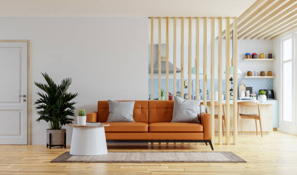 Living room interior wall mockup in warm tones with leather sofa which is behind the kitchen.