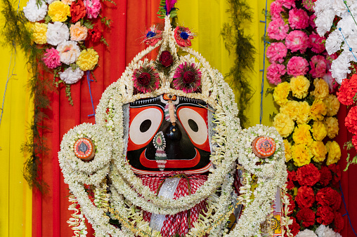 Idol of Hindu God Jagannath. Lord Jagannath is being worshipped with garlands for Rath jatra festival - at Howrah, West Bengal, India.