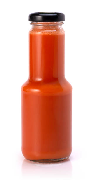 istock Fresh red tomato juice in glass bottle isolated on white 1327393986