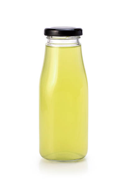 istock Yellow juice soft drink in glass bottle isolated on white 1327394015