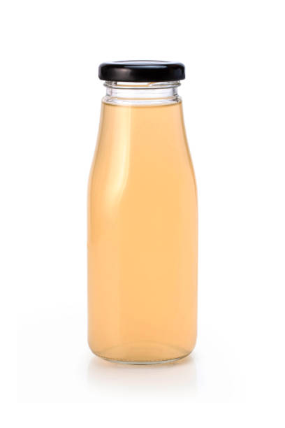 istock Orange apple cider vinegar or juice in glass bottle 1327394024