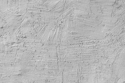 Texture of white plaster on the wall of an old house. Architectural design.