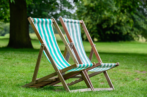 Two retro green deckchairs in Hyde Park, London