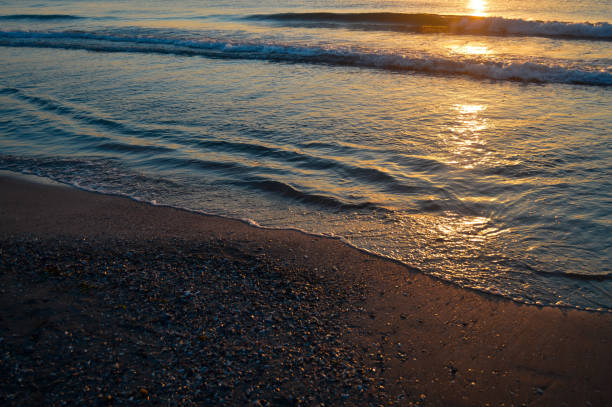 istock Beautiful summer sunset at the beach, waves and sand 1327404062