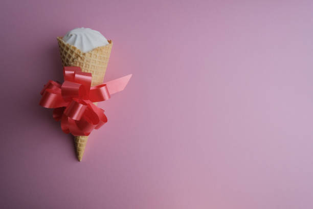 istock Sugar waffle tube with marshmallows, cremo on a pink background. 1327405788