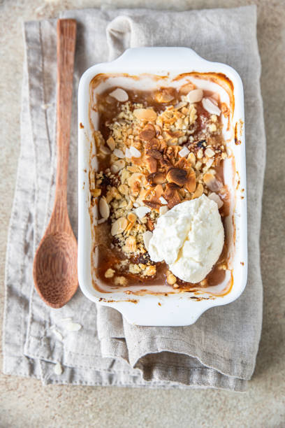 istock Plum crumble with vanilla ice cream. Summer crispy fruit dessert. Top view. 1327409053