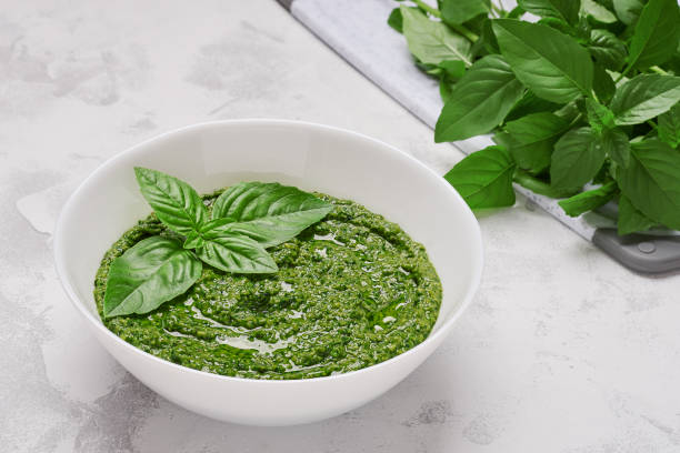 istock Bowl basil pesto bowl on light background close up 1327411060